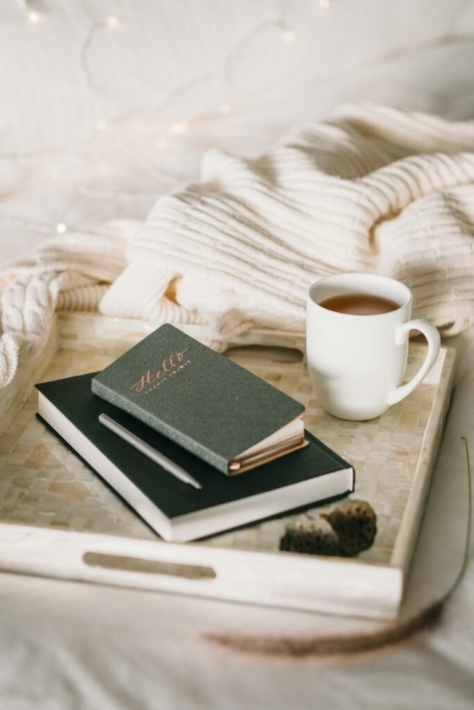 photo of cup beside books