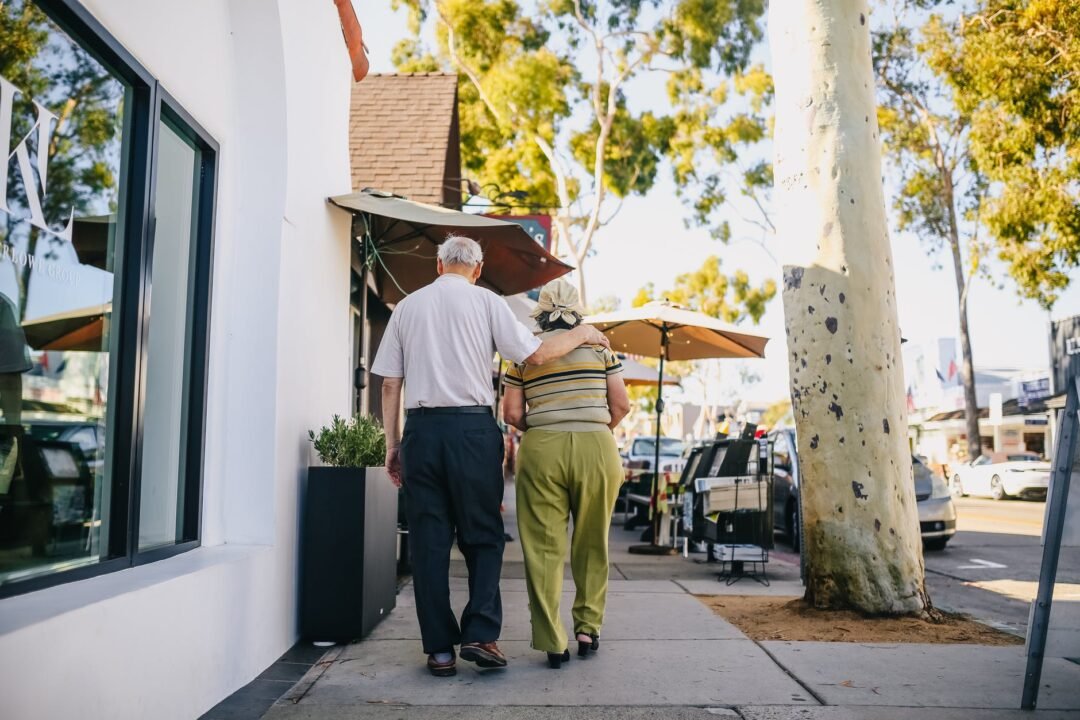 elderly couple walking on the street