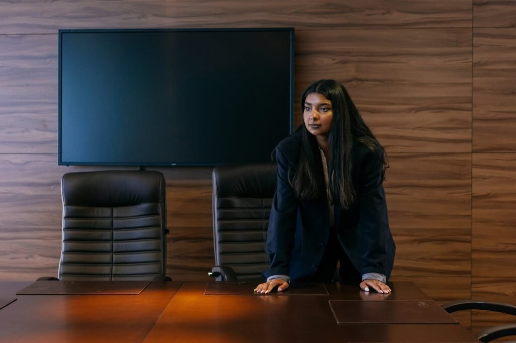 woman in black blazer beside wooden table